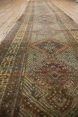 Vintage Serab runner's intricate geometric patterns in dark copper and mallard green.
