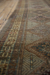 Hand-knotted vintage Serab runner displaying geometric motifs in copper, mallard green, and pale gold.