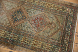 Vintage hand-knotted Serab rug with geometric motifs and muted copper, green, gold tones.