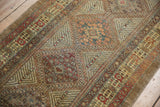 Serab runner's intricate geometric border in camel, dark red, and sage tones.