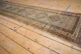 Vintage Serab runner's hand-knotted geometric patterns in muted copper, sage, and ivory.