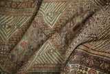Textured hand-knotted pile of a Serab runner, with geometric designs and earthen hues.