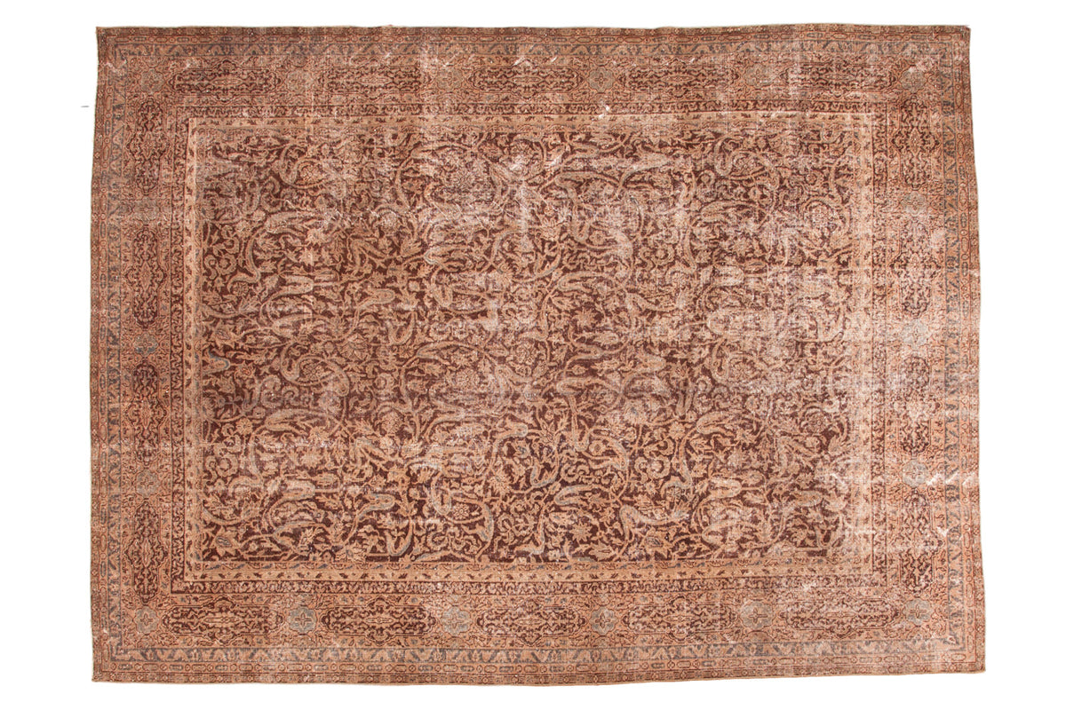 Distressed Vintage Oushak carpet with allover scrolling leaves and arabesques in brown, eggplant, sand, and silver. Features hard wear and exposed foundation, 8'8" x 11'8".