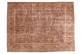 Distressed Vintage Oushak carpet with allover scrolling leaves and arabesques in brown, eggplant, sand, and silver. Features hard wear and exposed foundation, 8'8