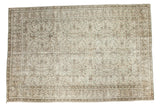 Distressed vintage Oushak rug with allover scrolling floral pattern in muted ivory and brown.