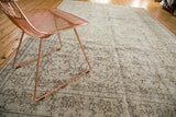 Distressed vintage Oushak hand-knotted rug, featuring faded ivory and brown allover floral patterns.