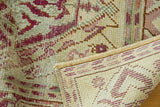 Distressed Oushak runner's textured pile with raspberry, blush, ivory tones, showing secure fringe.