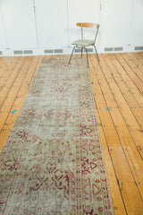 Distressed vintage Oushak runner, highlighting faded raspberry patterns on antique ivory ground.