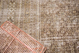 Distressed vintage Khorassan rug texture, faded allover pattern in cream and darker tones.
