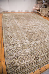 Distressed vintage Khorassan corner showing curvilinear border and soft charcoal, cream, silver hues.