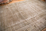 Distressed corner of a vintage Khorassan carpet, showing varied patterns and muted tones.