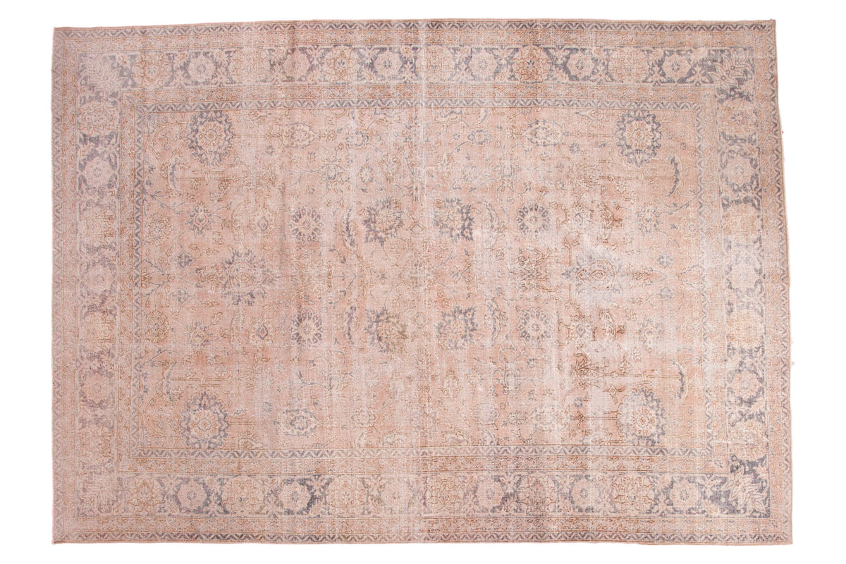 Distressed hand-knotted Turkish Oushak carpet with faded pink ivory and slate blue floral design.