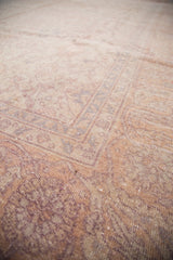 Close-up of distressed Oushak rug, showing soft cream, pink, and lavender pile.