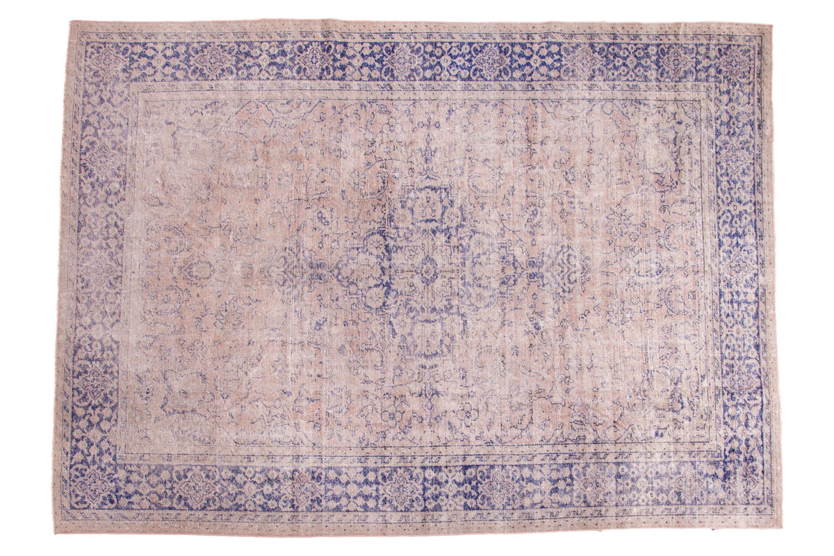 Distressed vintage Oushak rug, beige field, violet purple border, faded medallion.