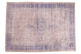 Distressed vintage Oushak rug, beige field, violet purple border, faded medallion.