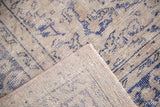 Secure edge and tight hand-knotted weave of the distressed vintage Oushak rug.