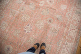 Distressed vintage Oushak rug texture with faded crevette pink, ivory, and seaglass blue.