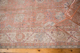 Faded crevette pink, ivory, and seaglass blue distressed vintage Oushak rug texture.
