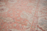 Faded crevette pink, ivory, and seaglass blue patterns with distressed texture on an Oushak rug.