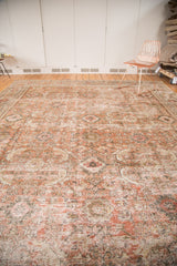 Close-up of distressed Mahal rug pile, showing soft terra-cotta, rose gold, and cream tones.
