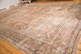 Distressed vintage Mahal rug corner, traditional borders in faded terra-cotta and slate blue-gray.
