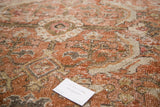 Distressed pile texture of the vintage Mahal rug in peach, cream, and olive tones.