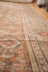 Distressed texture of a vintage Mahal rug, highlighting peachy-rose and blue-gray patterns.