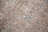 Distressed vintage Sivas rug texture featuring light blue accents on faded brown.