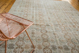 Distressed Vintage Oushak carpet displaying muted floral palmette patterns in soft wooded tones and aqua.