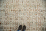 Distressed vintage Oushak carpet displaying muted floral palmettes with old patina.