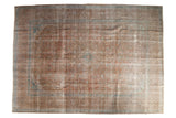 Distressed Vintage Kashan carpet, an intricate medallion design in muted bronze, rose, and aqua.