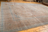 Distressed vintage Kashan carpet's muted bronze field and faded aqua blue borders.