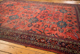Distressed vintage Mahal rug with a vibrant cherry red field and detailed floral border.