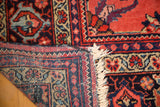 Vintage Mahal carpet corner reveals hand-knotted foundation, secure fringe, and colorful floral design.