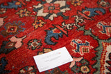 Bold cherry red Distressed Mahal carpet pile showing colorful motifs and wear.