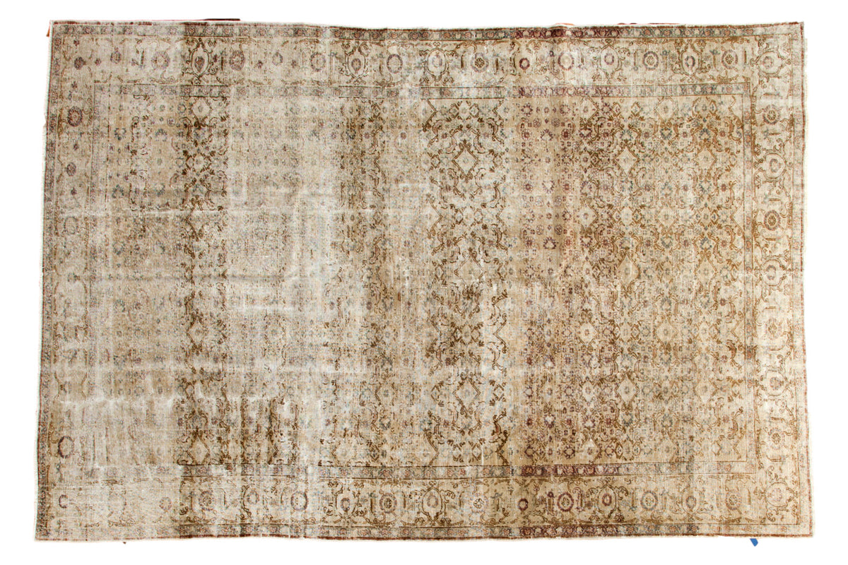 Distressed vintage Oushak carpet with faded allover floral vinery in ivory, gold, and slate grey, 7'1" x 10'7".