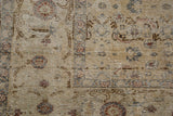 Distressed Oushak rug pile with intricate faded floral and vinery motifs.