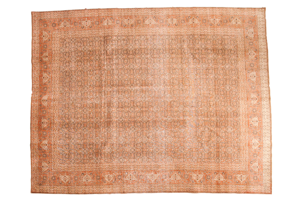 Distressed vintage hand knotted Persian Tabriz rug with subdued brown and faded rust, 9'8" x 12'6".
