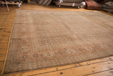 Subdued brown and faded rust pattern on a distressed vintage Tabriz carpet.