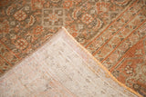Hand-knotted foundation revealed under faded rust and subdued brown distressed pile.