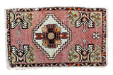 Blush vintage Oushak rug mat with a serrated diamond medallion and plant motifs, 1'7