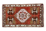 Vintage Oushak rug mat with large pale mauve geometric medallion, plant motifs, cinnabar red field.