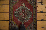 Scalloped medallion with blossom tree design and meandering leaf border on vintage Oushak rug.