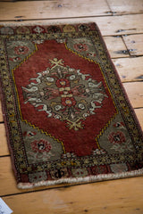 Vintage Oushak rug's scalloped medallion and decorative meandering leaf border in cinnabar red.