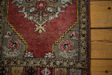 Vintage Oushak rug border detail with yellow zigzag, cinnabar red field, and grey leaf motifs.