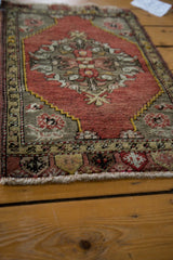 Decorative end finishing and meandering leaf border on the vintage Oushak rug.