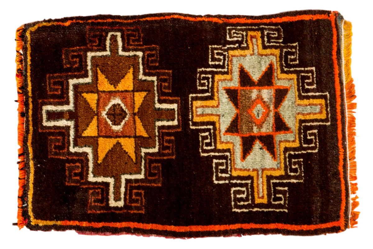 Vintage Oushak rug mat with tribal double starburst design in tangerine, saffron, chocolate, silver, and charcoal black.