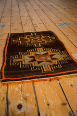 Hand-knotted Oushak rug detail showing tribal geometric starburst pattern and tangerine fringe.