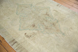 Vintage Turkish Oushak rug showing subtle seafoam green medallion and ivory pile with even wear.
