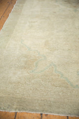 Subtle tone-on-tone pattern and texture of a vintage Oushak rug in antique ivory and sea foam.